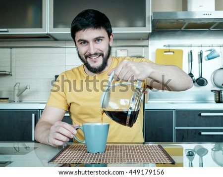 Funny cooking. Attractive caucasian man drinking coffee in the kitchen