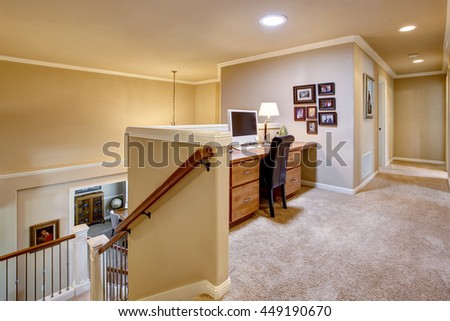 Small home office area in the hallway with carpet floor. View to downstairs