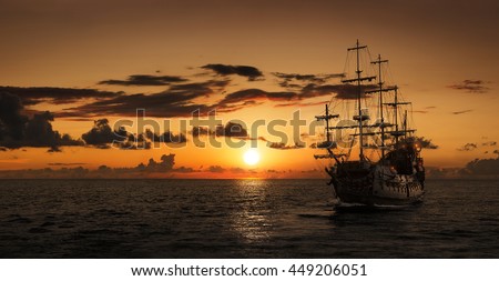 Pirate ship at the open sea at the sunset with copy space Royalty-Free Stock Photo #449206051
