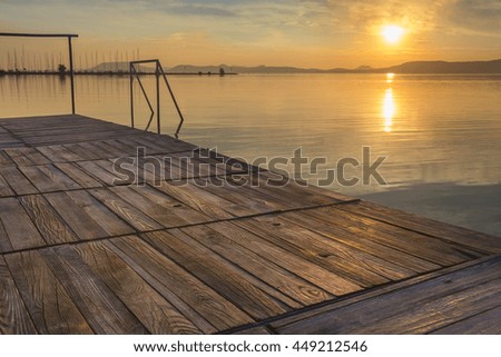 Balaton waterline at sunset watched from the wooden pier