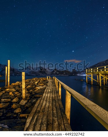 A walkway from the observation deck. Winter view to night sky over Mefjord on the Senja island, Troms county - Norway.