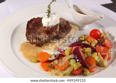 meat with vegetables and gravy on plate