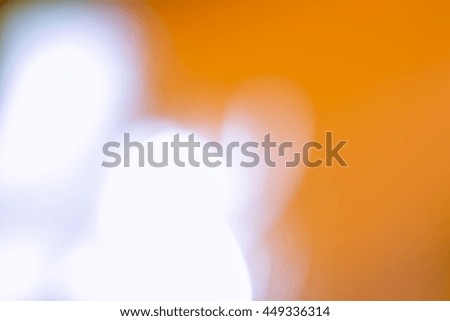 Blurry soft background. Over white and orange tones.