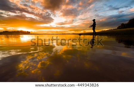 Fishing in lake with beautiful twilight sky background.