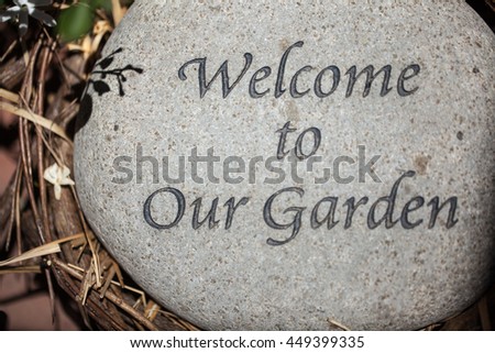 Welcome to our garden sign engraved on a stone.