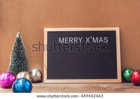 Christmas decoration, with Christmas tree and  blackboard on wooden floor as a background for your message to holiday Christmas and celebration time.