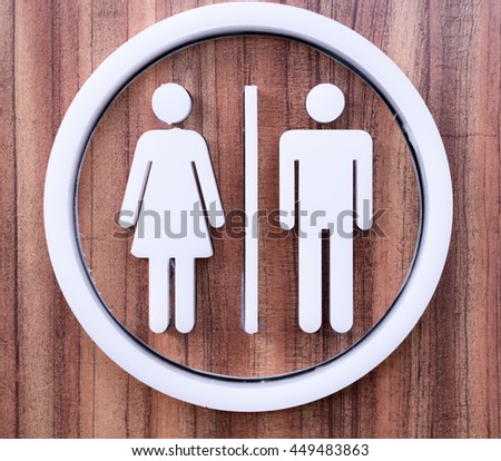 Sign Toilet symbols for man and women on the wooden background
