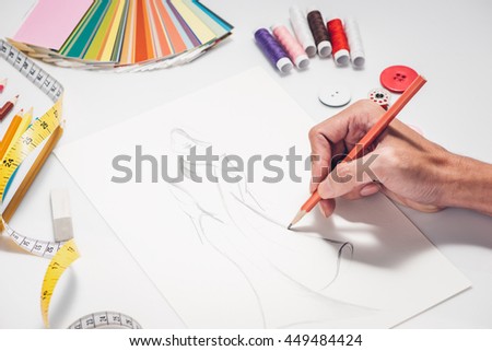 Close-up of designer drawing a fashion sketch