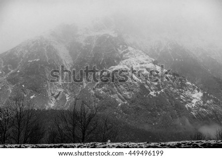 Mighty mountain covered in mist. Great snowy peak. Epic view wallpaper. Travel inspiration. Vacation concept. Picture is great for postcard. 