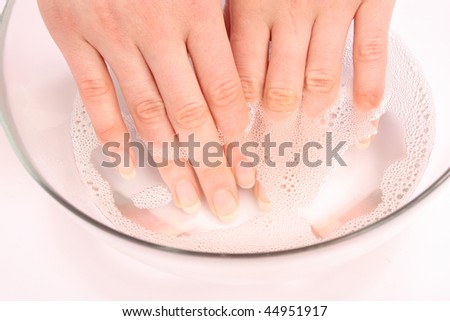 Well-groomed female hands in  glass bowl with soap water Royalty-Free Stock Photo #44951917