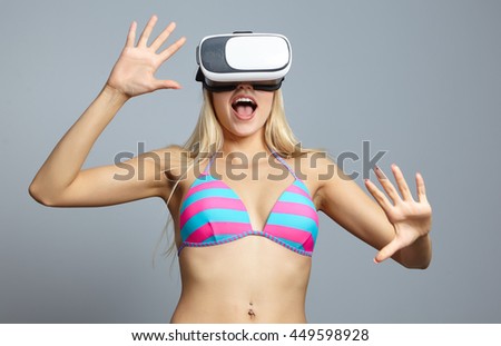 Girl wearing virtual reality goggles isolated on grey. Virtual vacations concept