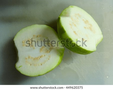 guavas on a plastic chopping block