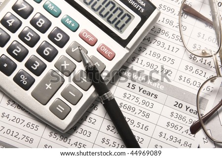 Calculator, Pen and Financial Paper.