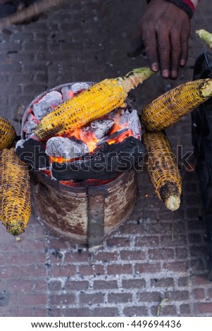 Hand roasted corn on the cob for sale by an outdoor street vendor in Nainital (Uttrakhand), India.