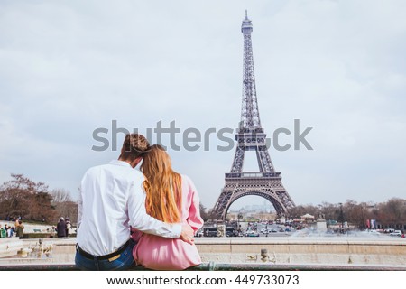 romantic couple looking at Eiffel tower in Paris, honeymoon background