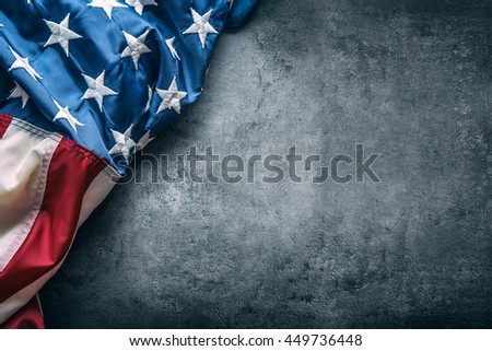 American flag freely lying on concrete board.