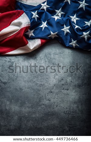 American flag freely lying on concrete board.