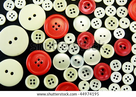 Old used Sewing buttons isolated on black