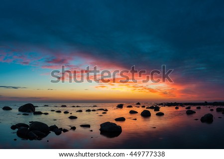 Sea and rocks with sunset sky.
