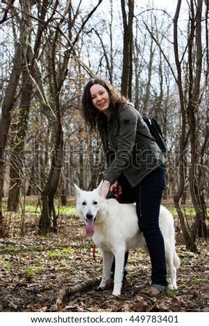 Woman and white swiss shepherd dog