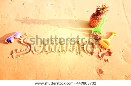 Summer Written in the Sand on a Beach.