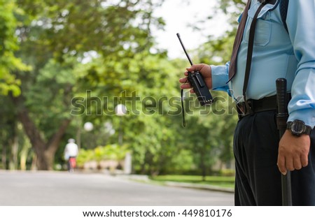 Security guard hand holding cb walkie-talkie radio,copy space.