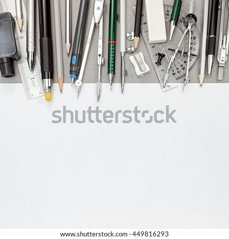 blank paper sheet with pens and pencils, drawing compass, protractor, eraser, sharpener, top view