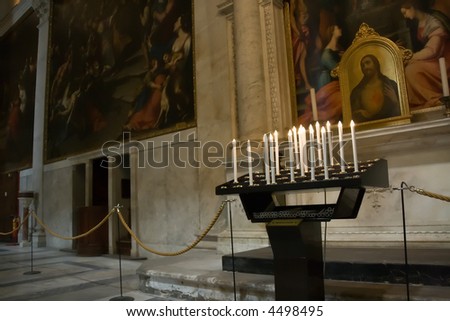 Electric candles in rich interior of a cathedral in Pisa in the field of miracles.