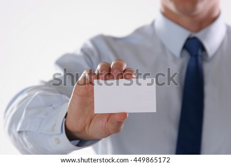 Close-up of business card in mans hand.