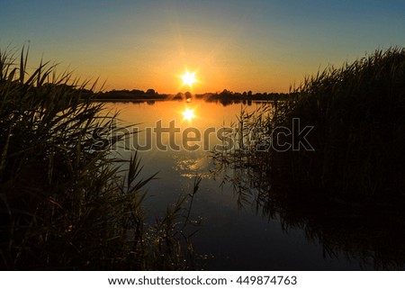 Scenic view of beautiful sunset above the pond at summer