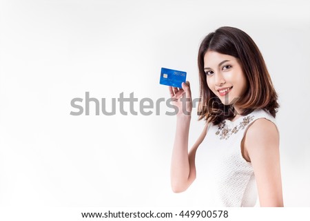 beautiful friendly smiling asia girl showing buld credit card in hand, isolated on white backgroud with copy space