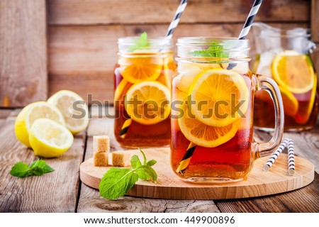 ice tea with slice of lemon in mason jar on the wooden rustic background Royalty-Free Stock Photo #449900896