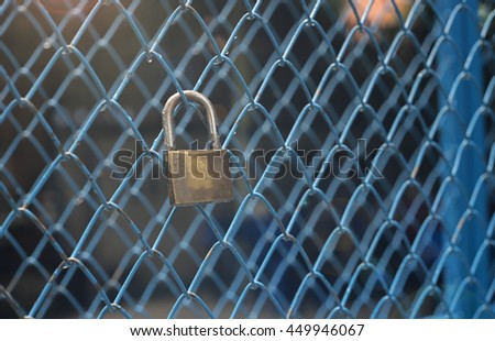 portrait of key lock hook on iron wire gates and water drop of rain with blur background,selective focus,filtered image,light and flare effect added