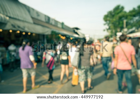 Abstract blur tourist shopping in Chatuchak weekend market outdoor in sunny day Bangkok Thailand background - Retro filter effect