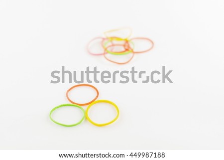 Colorful plastic band on white background.