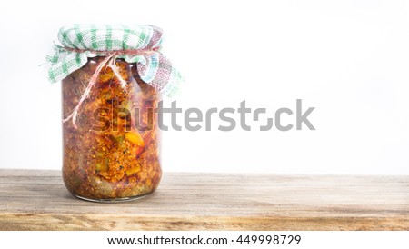 Jar of south indian homemade pickle on a wooden table - white background  Royalty-Free Stock Photo #449998729