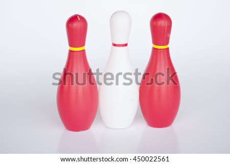 Glossy white,Glossy white and red  bowling skittles standing in row. Vect red and black bowling skittles standing in row. Vect