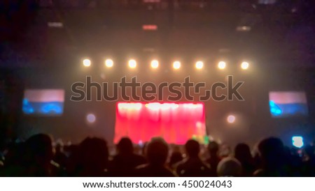 Crowd watching the stage performance , Blurry Stage show as abstract background
