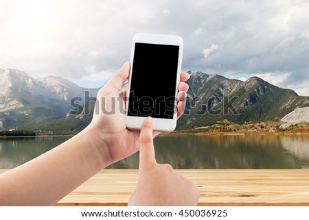 Female hand using mobile smartphone blurred background - mockup template, clipping path
