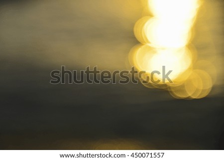 Out of focus bokeh background of water with sun reflections, water bokeh in the sea, bokeh of water and lights.