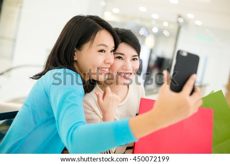 Friends take selfie together after shopping