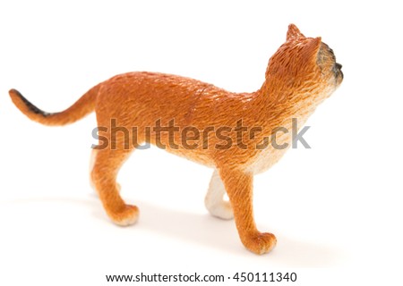 Toy cat from plastic on a white background