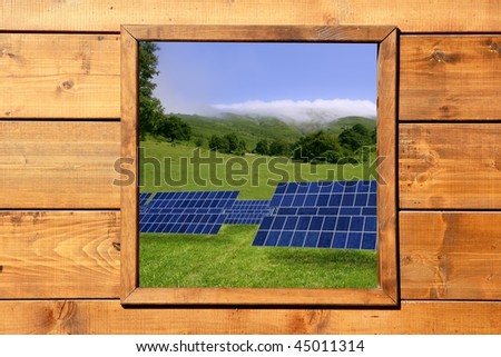 Solar plates meadow view from wooden window in a wood cabin [Photo Illustration]