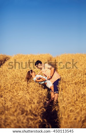Couple in love enjoying tender moments during sunset . Emotional concept of relationship with travel boyfriend and girlfriends relaxing together. guys are walking in wheat