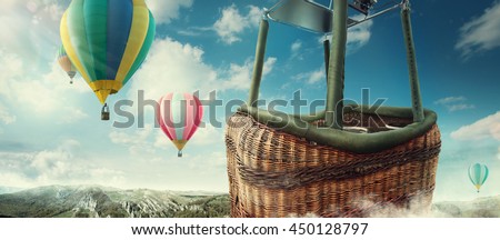 Travel and Tourism. Colorful hot-air balloons flying over the mountain. Close view on basket Royalty-Free Stock Photo #450128797