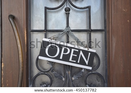 Open sign hanging in front of the door
