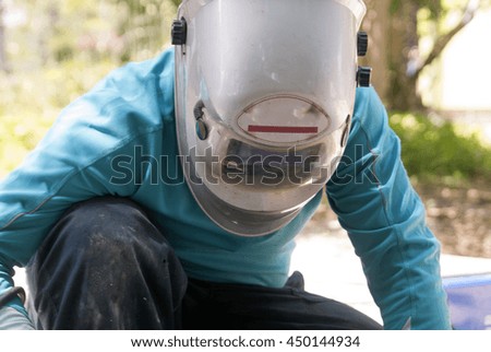 Welder worker welding metal. Bright electric arc and sparks