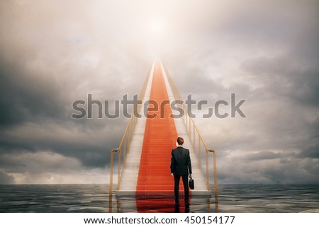 Success concept with businessman climbing concrete stairs in the sky.