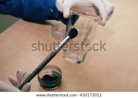 Expert takes fingerprints from a glass Royalty-Free Stock Photo #450172012