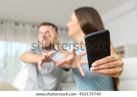 Angry couple or marriage fighting for a mobile phone at home Royalty-Free Stock Photo #450179740